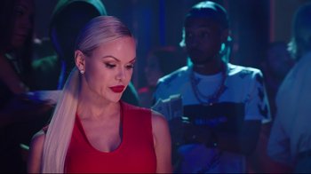 Movie still from “How High 2” (2019), directed by Bruce Leddy – A woman in a red dress is looking at a man in a blue shirt; Medium shot, Over the shoulder angle