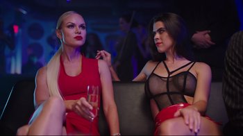 Movie still from “How High 2” (2019), directed by Bruce Leddy – Two women sitting next to each other holding a wine glass; Medium shot, Over the shoulder angle