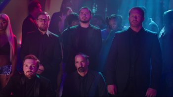 Movie still from “How High 2” (2019), directed by Bruce Leddy – A group of men standing in front of a crowd; Medium shot, Low angle