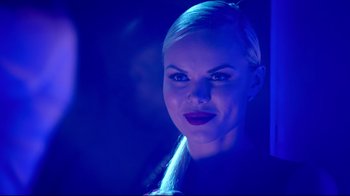 Movie still from “How High 2” (2019), directed by Bruce Leddy – A woman in a black shirt is in a blue light; Close Up shot, Over the shoulder angle