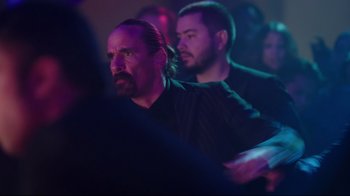 Movie still from “How High 2” (2019), directed by Bruce Leddy – A man in a black shirt is in a crowd; Medium shot, Over the shoulder angle