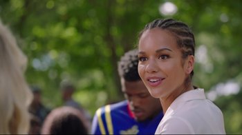 Movie still from “How High 2” (2019), directed by Bruce Leddy – A young woman smiles at the camera while a man stands behind her; Close Up shot, Over the shoulder angle