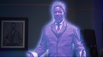 Movie still from “How High 2” (2019), directed by Bruce Leddy – A man in a suit and tie standing in front of a picture; Medium shot, High angle