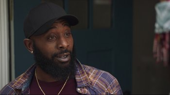 Movie still from “How High 2” (2019), directed by Bruce Leddy – A person with a beard wearing a hat; Close Up shot, Over the shoulder angle