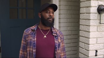 Movie still from “How High 2” (2019), directed by Bruce Leddy – A man with a beard wearing a hat and a plaid shirt; Medium shot, Low angle