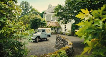Movie still from “How I Live Now” (2013), directed by Kevin Macdonald – An old truck parked in front of a house; Extreme Wide shot, Low angle