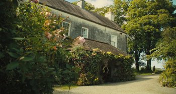 Movie still from “How I Live Now” (2013), directed by Kevin Macdonald – A house that has a lot of flowers growing around it; Extreme Wide shot, Low angle