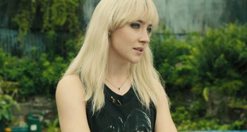 Movie still from “How I Live Now” (2013), directed by Kevin Macdonald – A woman with long blonde hair wearing a black shirt; Close Up shot, High angle