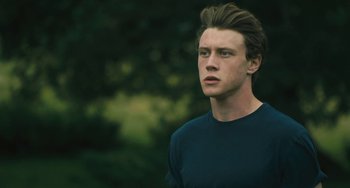 Movie still from “How I Live Now” (2013), directed by Kevin Macdonald – A young man is looking into the distance; Close Up shot, Low angle