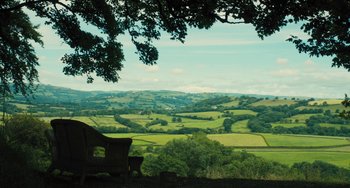 Movie still from “How I Live Now” (2013), directed by Kevin Macdonald – A view of a lush green countryside from a hill; Extreme Wide shot, High angle