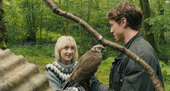Movie still from “How I Live Now” (2013), directed by Kevin Macdonald – A man and a woman are holding a hawk; Close Up shot, Over the shoulder angle