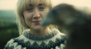Movie still from “How I Live Now” (2013), directed by Kevin Macdonald – A person wearing a sweater; Close Up shot, Over the shoulder angle