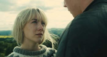 Movie still from “How I Live Now” (2013), directed by Kevin Macdonald – A woman and a man standing next to each other; Close Up shot, Over the shoulder angle