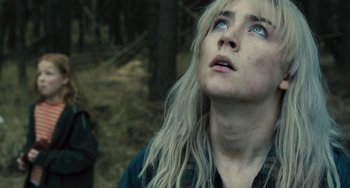 Movie still from “How I Live Now” (2013), directed by Kevin Macdonald – A person looking up at the sky; Close Up shot, Low angle