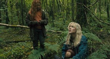 Movie still from “How I Live Now” (2013), directed by Kevin Macdonald – Two people in the woods looking at each other; Medium shot, Low angle