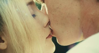 Movie still from “How I Live Now” (2013), directed by Kevin Macdonald – A man and a woman kissing; Extreme Close Up shot, Over the shoulder angle