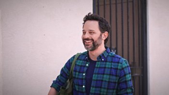 Movie still from “How It Ends” (2021), directed by Daryl Wein – A man with a beard is smiling for the camera; Medium shot, High angle