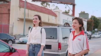 Movie still from “How It Ends” (2021), directed by Daryl Wein – Two young women standing on the side of the street; Medium shot, Low angle