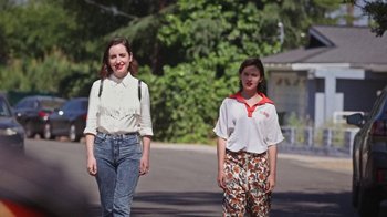 Movie still from “How It Ends” (2021), directed by Daryl Wein – Two young women walking down the street together; Medium shot, Low angle