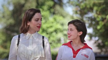 Movie still from “How It Ends” (2021), directed by Daryl Wein – Two young women standing next to each other in a park; Close Up shot, Low angle