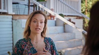Movie still from “How It Ends” (2021), directed by Daryl Wein – A woman standing in front of some stairs; Medium shot, High angle