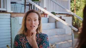 Movie still from “How It Ends” (2021), directed by Daryl Wein – A beautiful woman sitting in front of a staircase; Close Up shot, High angle
