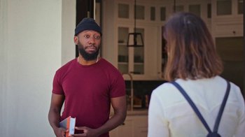 Movie still from “How It Ends” (2021), directed by Daryl Wein – A man and a woman standing in front of each other holding books; Medium shot, Over the shoulder angle