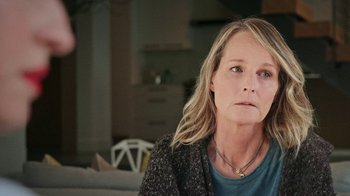 Movie still from “How It Ends” (2021), directed by Daryl Wein – A person sitting on a couch; Close Up shot, Over the shoulder angle