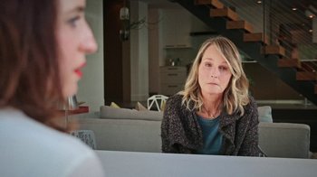 Movie still from “How It Ends” (2021), directed by Daryl Wein – A woman sitting in front of another woman in front of a table; Close Up shot, Over the shoulder angle