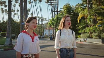 Movie still from “How It Ends” (2021), directed by Daryl Wein – Two young women standing on the side of the road; Medium shot, Low angle