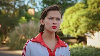 Movie still from “How It Ends” (2021), directed by Daryl Wein – A young woman with a red and white striped shirt; Close Up shot, Low angle