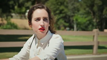 Movie still from “How It Ends” (2021), directed by Daryl Wein – A woman with red lipstick sitting in a park; Close Up shot, High angle