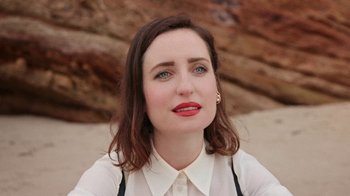 Movie still from “How It Ends” (2021), directed by Daryl Wein – A person wearing a white shirt; Close Up shot, High angle