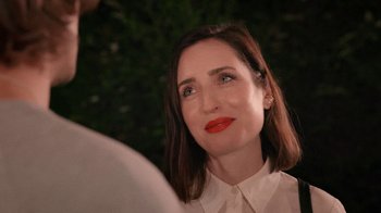 Movie still from “How It Ends” (2021), directed by Daryl Wein – A person wearing a white shirt and red lipstick; Close Up shot, Over the shoulder angle