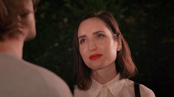 Movie still from “How It Ends” (2021), directed by Daryl Wein – A person wearing a white shirt and red lipstick; Close Up shot, Over the shoulder angle