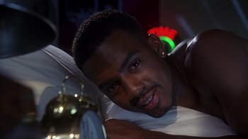 Movie still from “How to Be a Player” (1997), directed by Lionel C. Martin – A person laying on a bed; Close Up shot, High angle