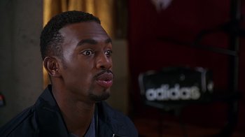 Movie still from “How to Be a Player” (1997), directed by Lionel C. Martin – A person sitting in front of a camera; Close Up shot, Over the shoulder angle