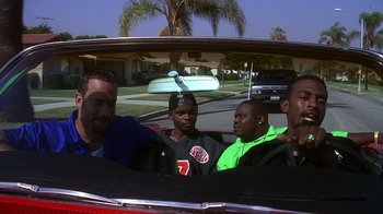 Movie still from “How to Be a Player” (1997), directed by Lionel C. Martin – A group of men sitting in the back of a car; Medium shot, Over the shoulder angle