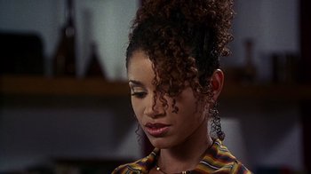 Movie still from “How to Be a Player” (1997), directed by Lionel C. Martin – A person with curly black hair; Close Up shot, Over the shoulder angle