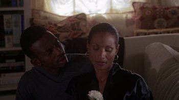 Movie still from “How to Be a Player” (1997), directed by Lionel C. Martin – A man and a woman sitting in a living room together; Close Up shot, Over the shoulder angle