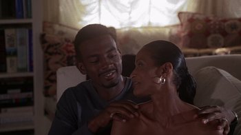 Movie still from “How to Be a Player” (1997), directed by Lionel C. Martin – A man and a woman sitting on a couch; Close Up shot, High angle