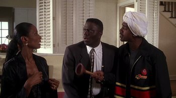 Movie still from “How to Be a Player” (1997), directed by Lionel C. Martin – A group of men standing next to each other in front of a window; Medium shot, Low angle