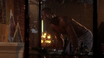 Movie still from “How to Be a Player” (1997), directed by Lionel C. Martin – A man in his underwear looking into a mirror; Medium shot, Low angle