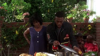 Movie still from “How to Be a Player” (1997), directed by Lionel C. Martin – A man and a woman preparing food on a table; Medium shot, Over the shoulder angle