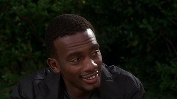 Movie still from “How to Be a Player” (1997), directed by Lionel C. Martin – A person smiling with trees in the background; Close Up shot, Over the shoulder angle