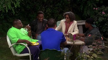 Movie still from “How to Be a Player” (1997), directed by Lionel C. Martin – A group of people sitting around a table; Medium shot, High angle