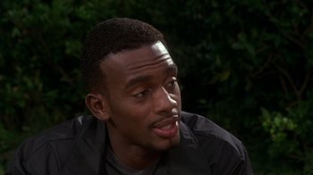 Movie still from “How to Be a Player” (1997), directed by Lionel C. Martin – A person sitting down with his mouth open; Close Up shot, Over the shoulder angle