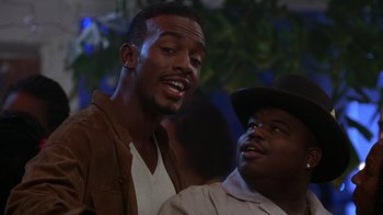 Movie still from “How to Be a Player” (1997), directed by Lionel C. Martin – A man and a man standing next to each other; Close Up shot, Low angle