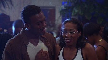 Movie still from “How to Be a Player” (1997), directed by Lionel C. Martin – A man and a woman standing next to each other; Close Up shot, Over the shoulder angle