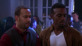 Movie still from “How to Be a Player” (1997), directed by Lionel C. Martin – A couple of men standing next to each other; Medium shot, Over the shoulder angle